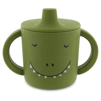 Green silicone sippy cup with dinosaur face and big handles for easy grip and spill-proof drinking