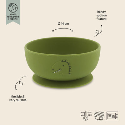 Green silicone bowl with suction base featuring dinosaur design, flexible, durable, and heat resistant for versatile use.